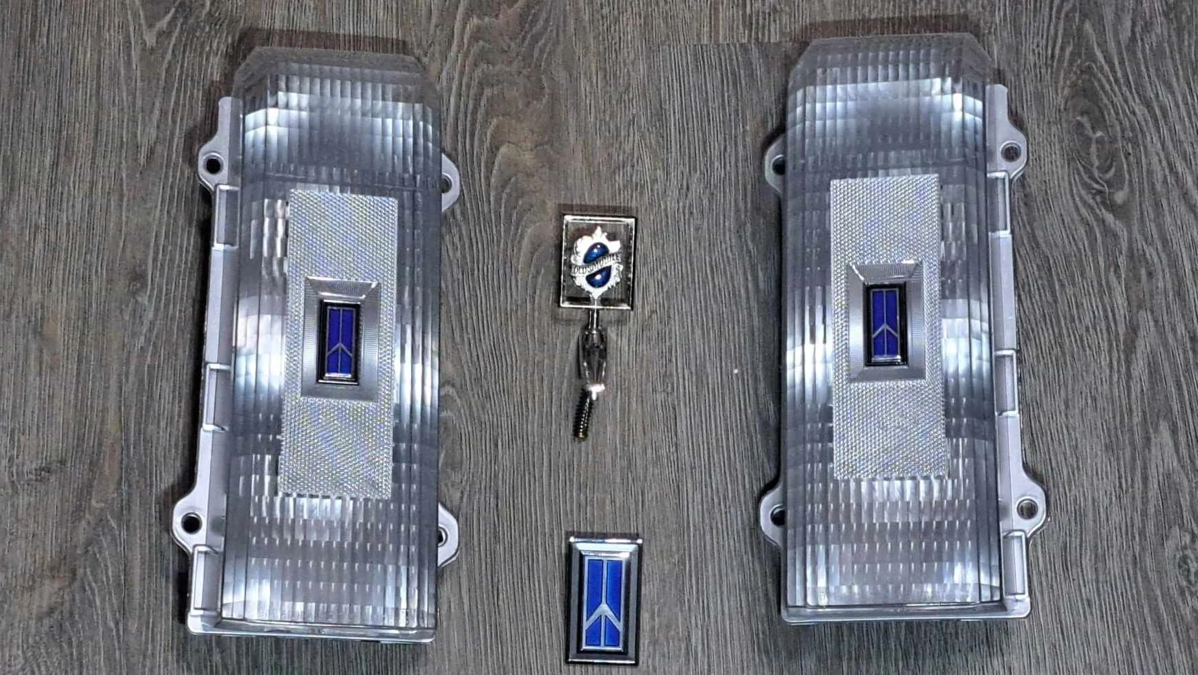 1986-1988 Cutlass clear tail light set with custom blue emblems and ornaments